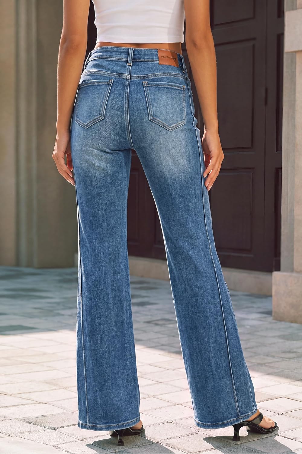 Arach&Cloz blue bootcut jeans, back view showing rear pockets and waistband label